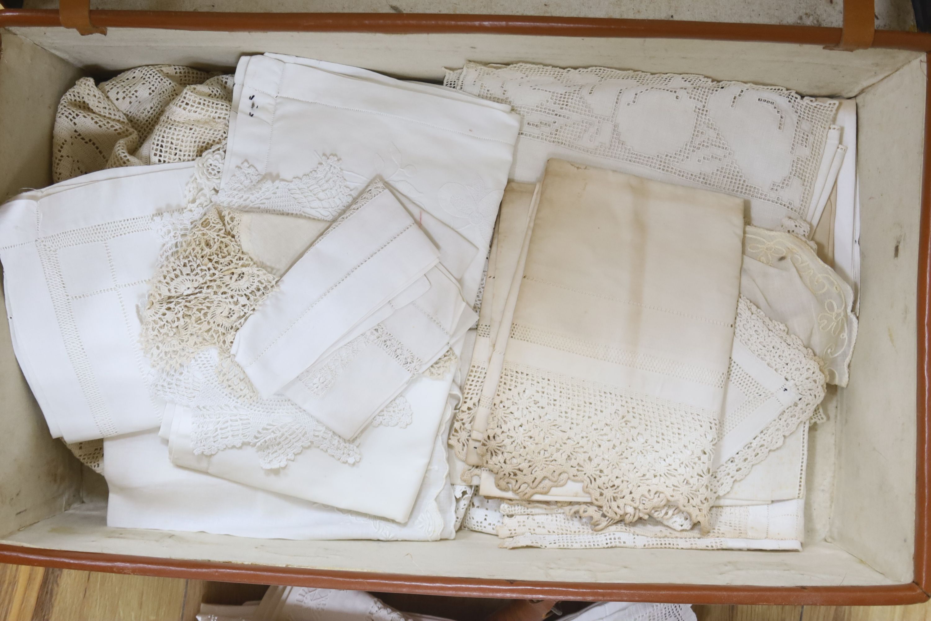 A brown leather suitcase of table linens